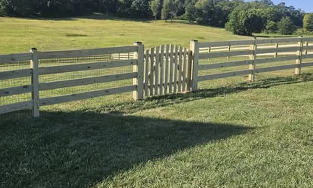 sliding-and-swinging-gates-in-winchester-with-wooden-fence-and-field