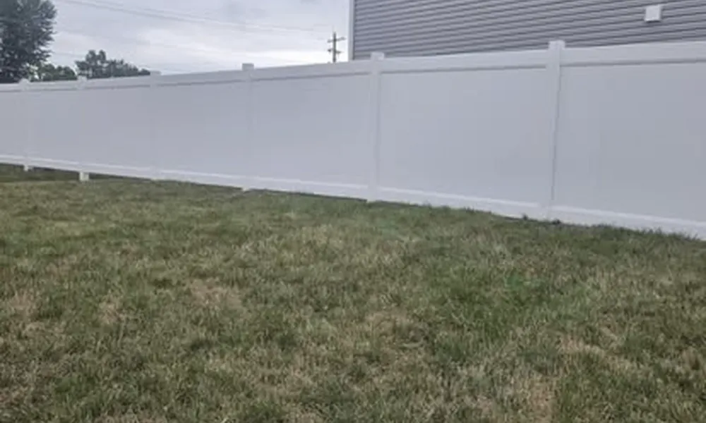 white-fence-installed-for-safety-in-backyard-with-grass