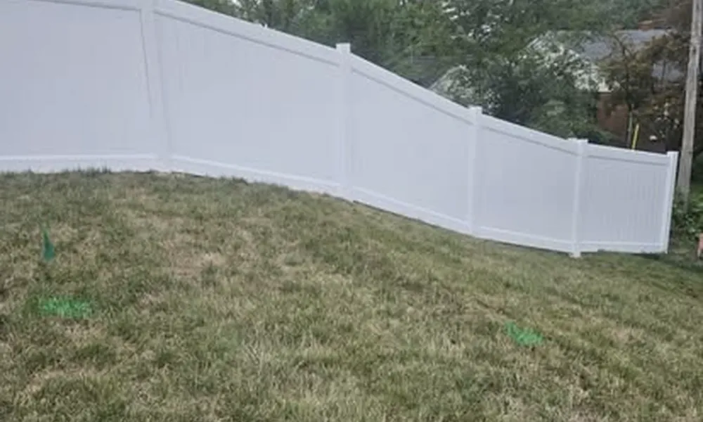 white-fence-on-sloped-yard-with-safety-precautions-in-place